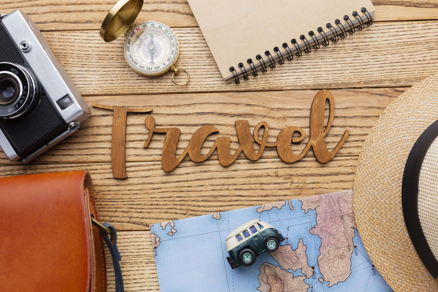top view traveling items wooden background min